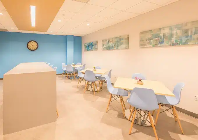 A room in the Gaithersburg outpatient treatment center with tables and chairs arranged comfortably.